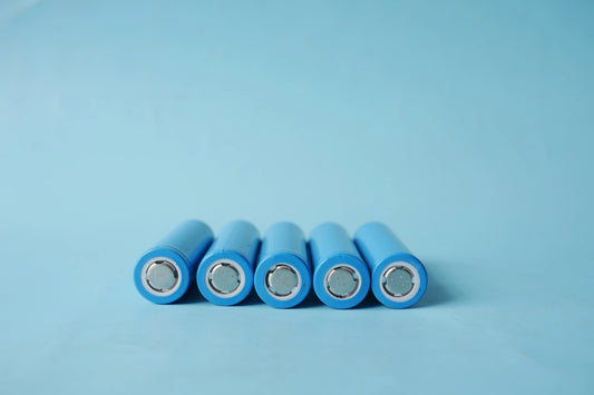 Unas pilas de litio recargable, son de color azul y están acostadas sobre una mesa 
